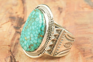 Genuine High Grade Kingman Turquoise set in Sterling Silver Ring. Beautiful Spider Web Matrix. The Kingman Turquoise Mine is located in Mohave County, Arizona. Created by Navajo Artist John Nelson. Signed by the artist.